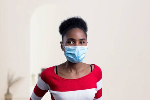 African American woman with blue mask on