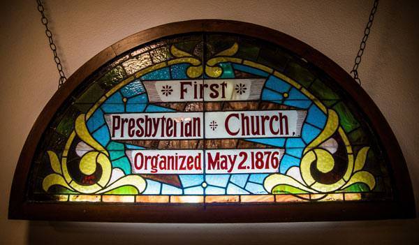 Stained glass window with the words "First Presbyterian Church Organized May 2, 1876"