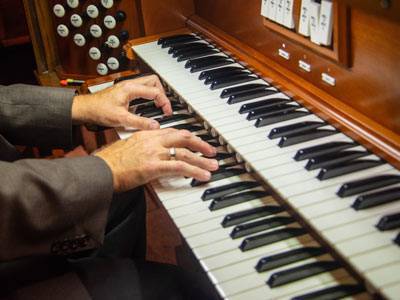 Man hands playing organ
